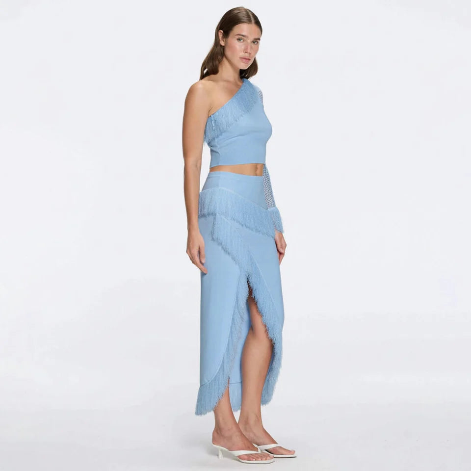 Monroe Blue One-Shoulder Knit Top with Fringe & Mesh Sleeve | Moeva | Crop Top | Each week unveils new pieces—luxury swimwear, fluid resort silhouettes, and elevated summer-to-evening essentials designed to carry you from coastal escapes to city nights.