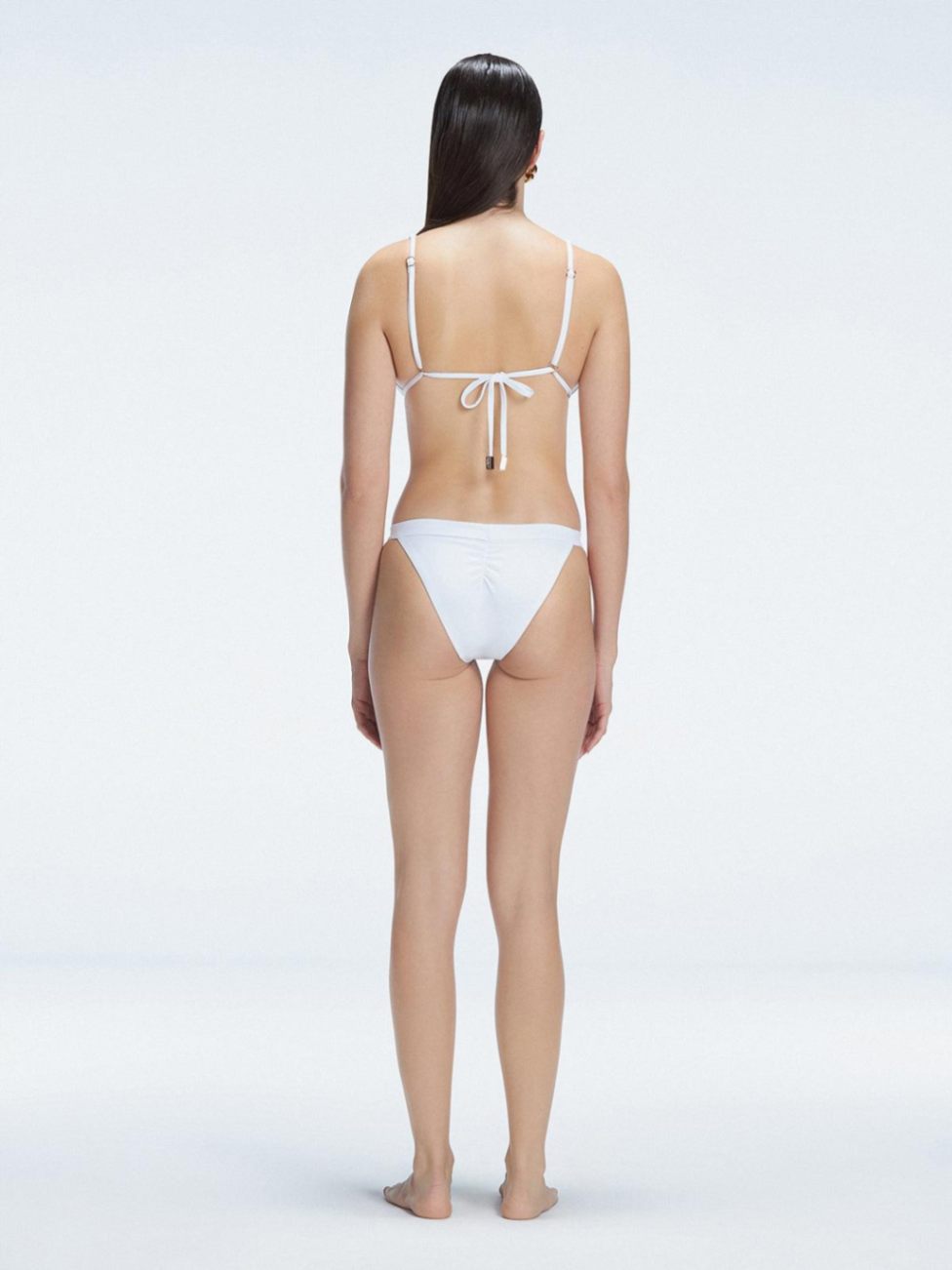 Zella White Mid Coverage Solid Bikini Bottom | Moeva | Bikini Bottom | Each week unveils new pieces—luxury swimwear, fluid resort silhouettes, and elevated summer-to-evening essentials designed to carry you from coastal escapes to city nights.