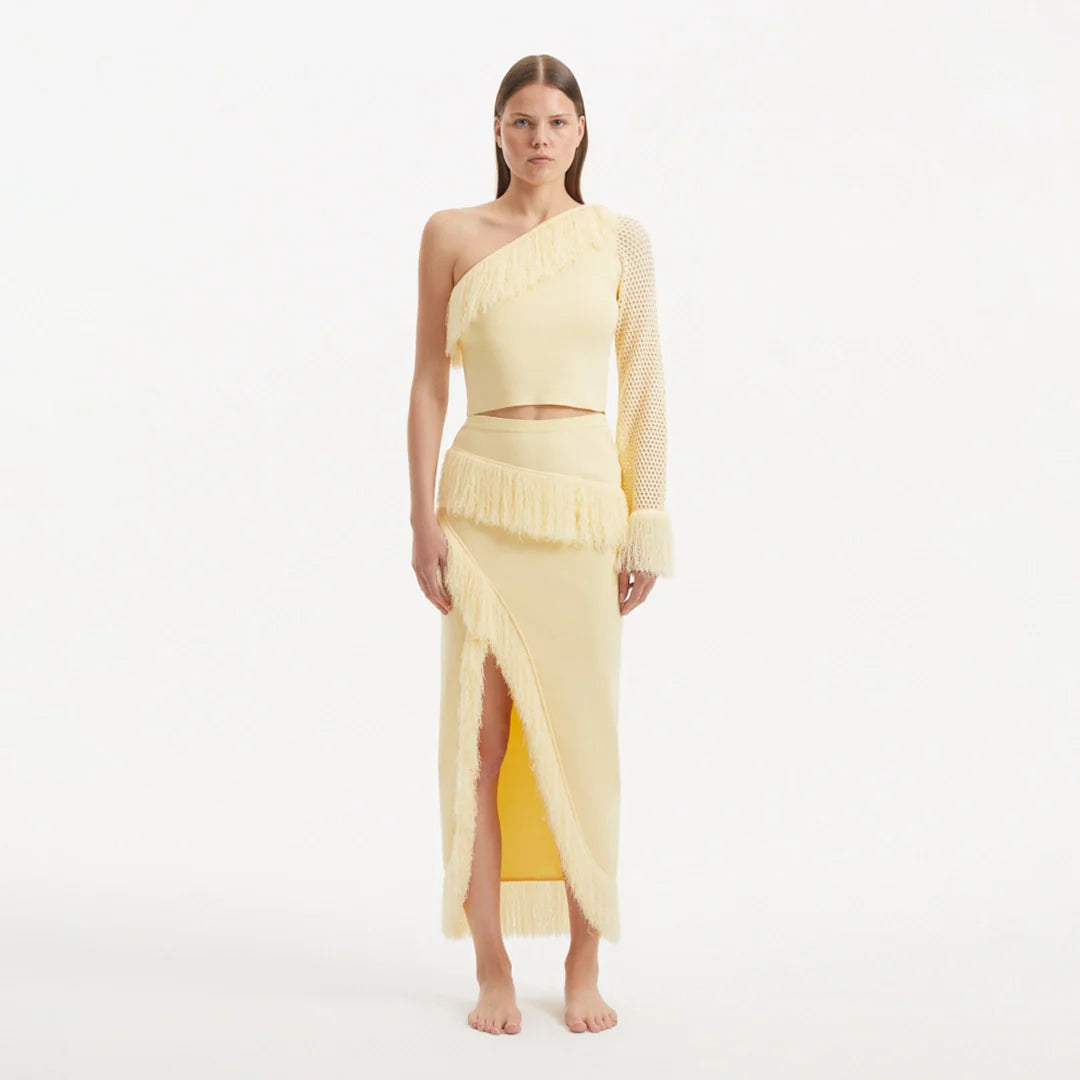 Monroe Yellow One-Shoulder Knit Top with Fringe & Mesh Sleeve | Moeva | Crop Top | Each week unveils new pieces—luxury swimwear, fluid resort silhouettes, and elevated summer-to-evening essentials designed to carry you from coastal escapes to city nights.