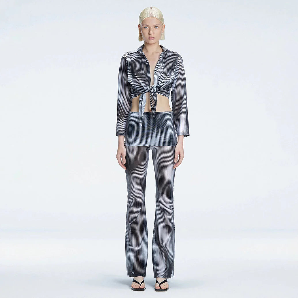 Greta Long Sleeve Tie Front Shirt and Freya High Waist Pants Black Optical Set | Moeva | Set | Each week unveils new pieces—luxury swimwear, fluid resort silhouettes, and elevated summer-to-evening essentials designed to carry you from coastal escapes to city nights.