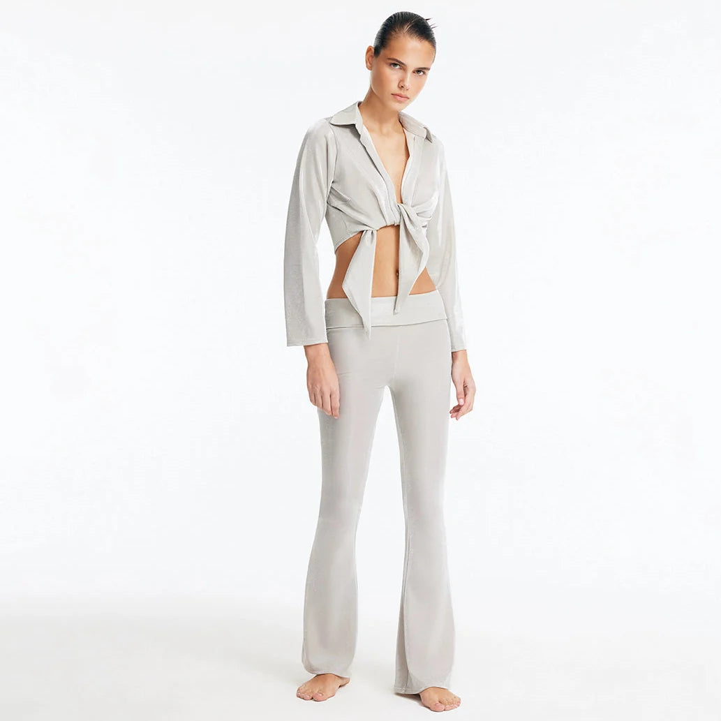 Greta Silver Long Sleeve Tie Front Shirt and Izara Mid-Rise Flared Pants | Moeva | Set | Each week unveils new pieces—luxury swimwear, fluid resort silhouettes, and elevated summer-to-evening essentials designed to carry you from coastal escapes to city nights.