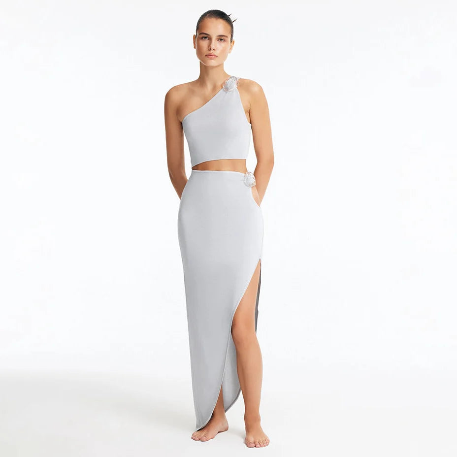Eila Silver One Shoulder Knitted Crop Top and Lyndon Silver Knitted Skirt with Side Slit | Moeva | Set | Each week unveils new pieces—luxury swimwear, fluid resort silhouettes, and elevated summer-to-evening essentials designed to carry you from coastal escapes to city nights.