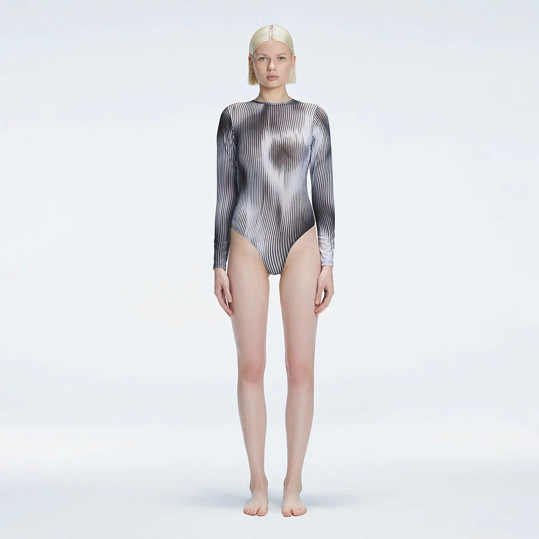 Mireya Black Optical Long Sleeve Bodysuit | Moeva | Crop Top | Each week unveils new pieces—luxury swimwear, fluid resort silhouettes, and elevated summer-to-evening essentials designed to carry you from coastal escapes to city nights.
