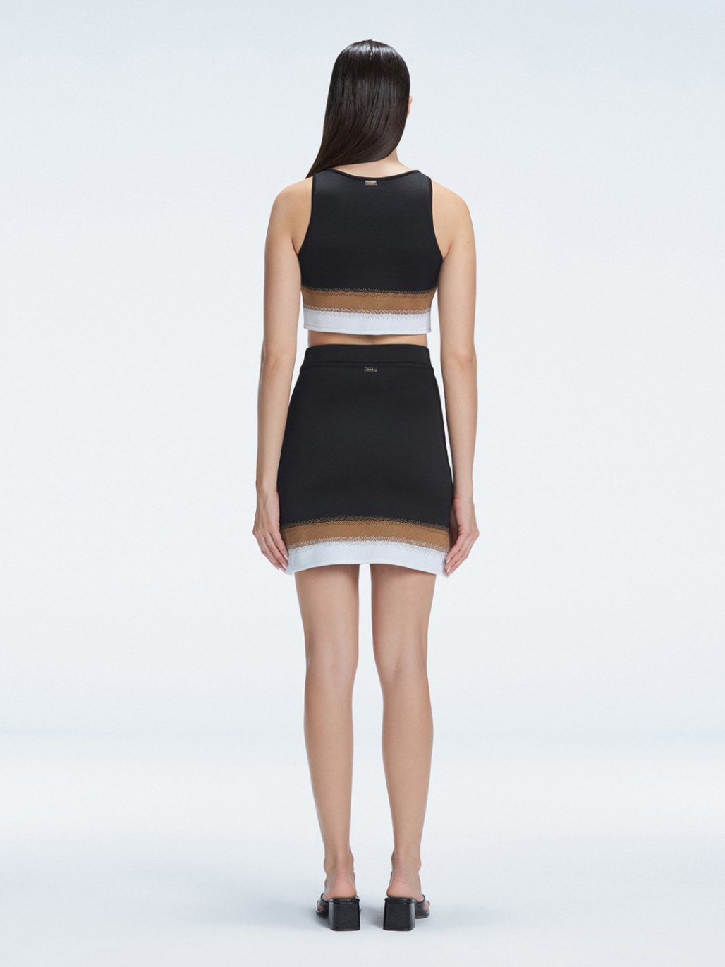 Lydia Black Optical Knit Mini Skirt | Moeva | Skirt | Each week unveils new pieces—luxury swimwear, fluid resort silhouettes, and elevated summer-to-evening essentials designed to carry you from coastal escapes to city nights.