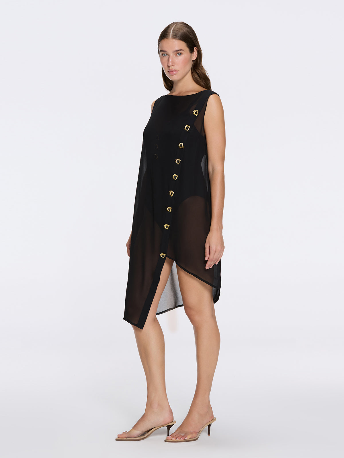 Solianne Black Sheer Sleeveless Asymmetric Dress with Gold Button Detail | Moeva | Dress | Each week unveils new pieces—luxury swimwear, fluid resort silhouettes, and elevated summer-to-evening essentials designed to carry you from coastal escapes to city nights.