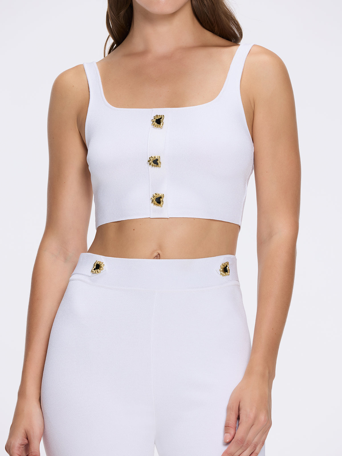 Aureline White Knitted Scoop Neck Gold Buttoned Crop Top | Moeva | Crop Top | Each week unveils new pieces—luxury swimwear, fluid resort silhouettes, and elevated summer-to-evening essentials designed to carry you from coastal escapes to city nights.