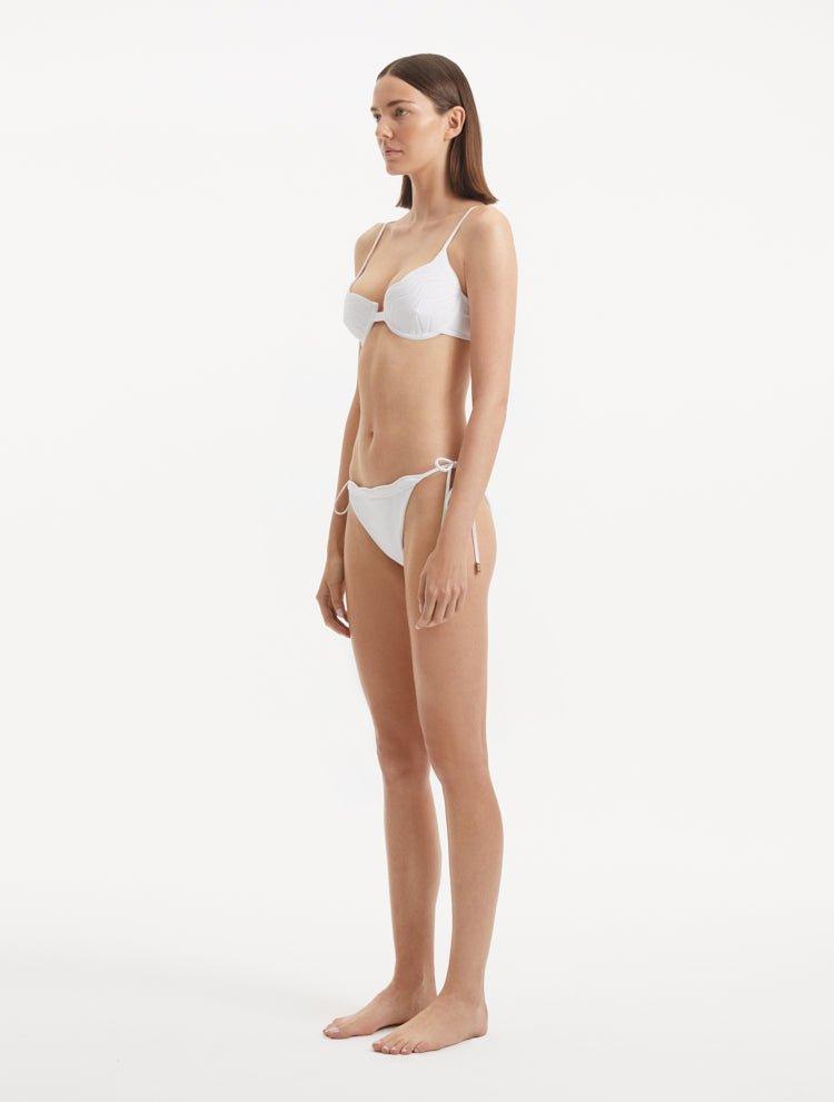 Salila White Side Tie Wave Textured Bikini Bottom | Moeva | Bikini Bottom | Each week unveils new pieces—luxury swimwear, fluid resort silhouettes, and elevated summer-to-evening essentials designed to carry you from coastal escapes to city nights.